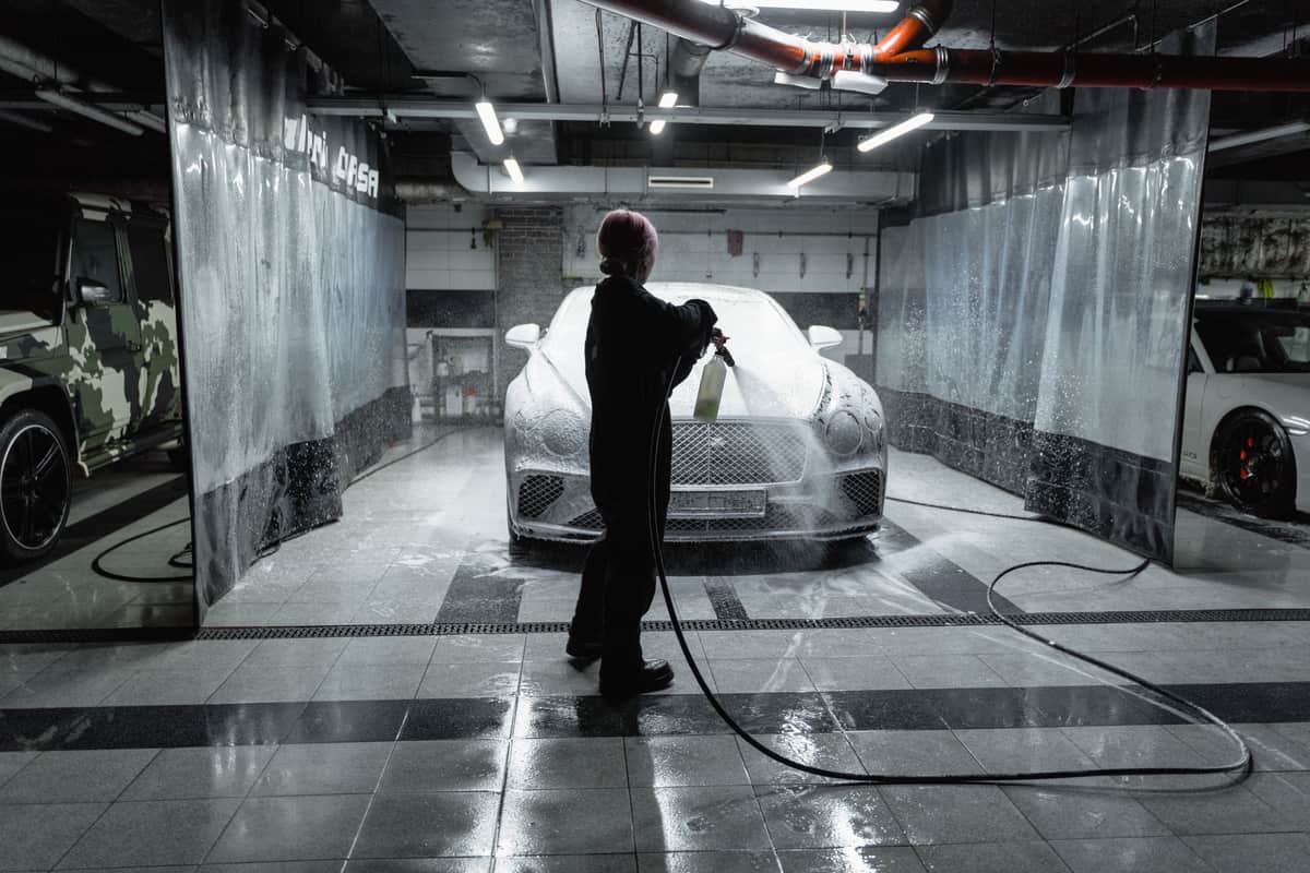 A clean two-car home garage with space for a wall-mounted charger