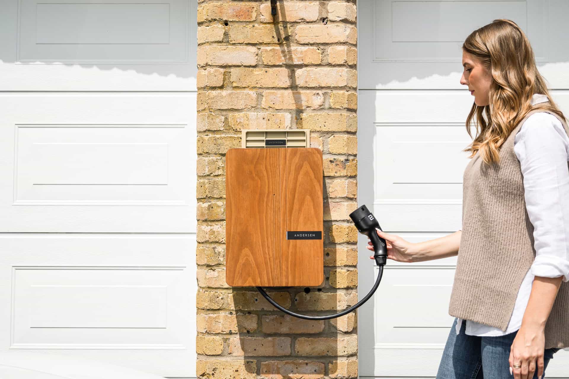 An electric car plugged in and charging inside a home garage