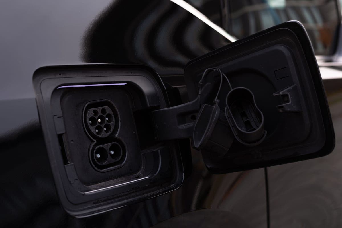 Close-up of an electric vehicle charging port on a car